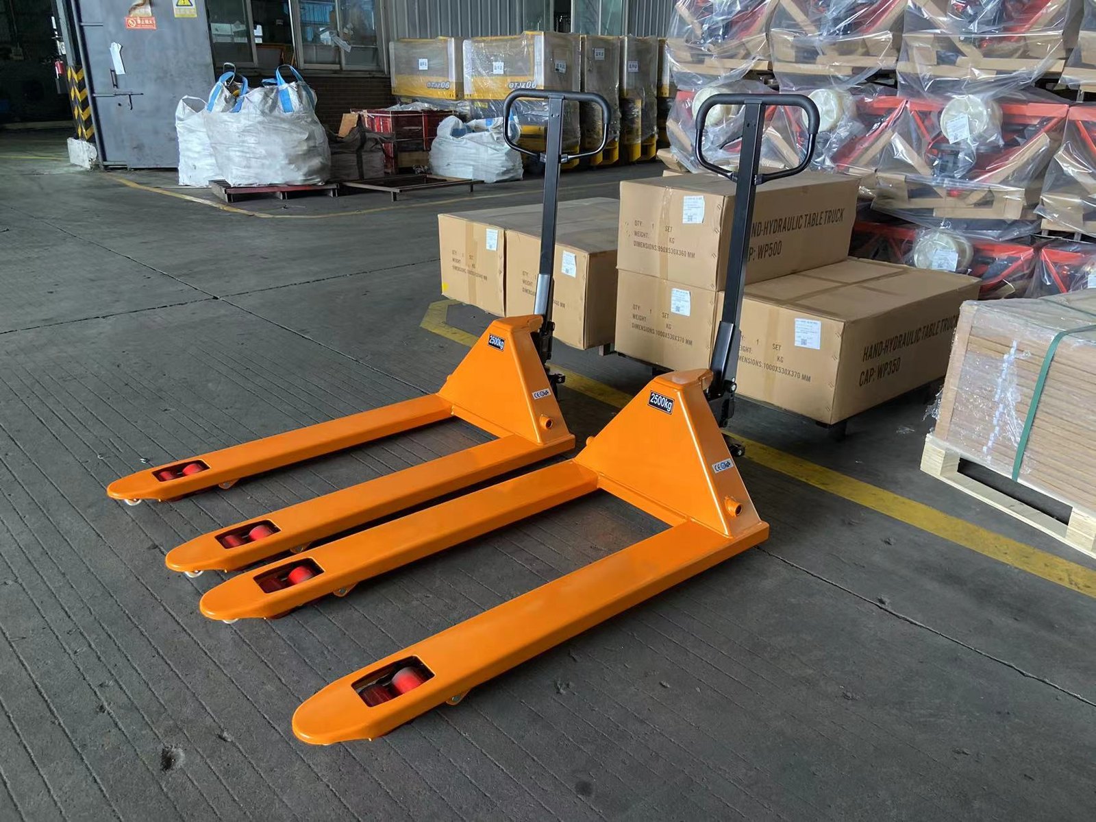 Manual pallet trucks ready in a warehouse